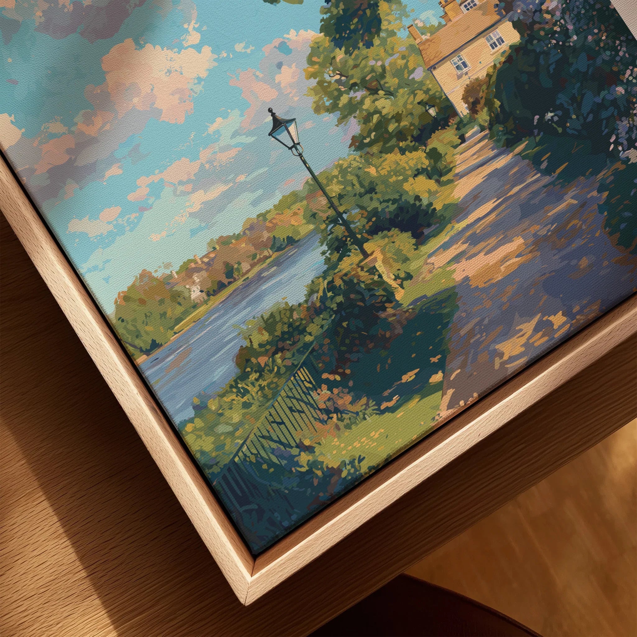 Closeup of a framed canvas wall art featuring a scenic river, trees, and sunlit path.
