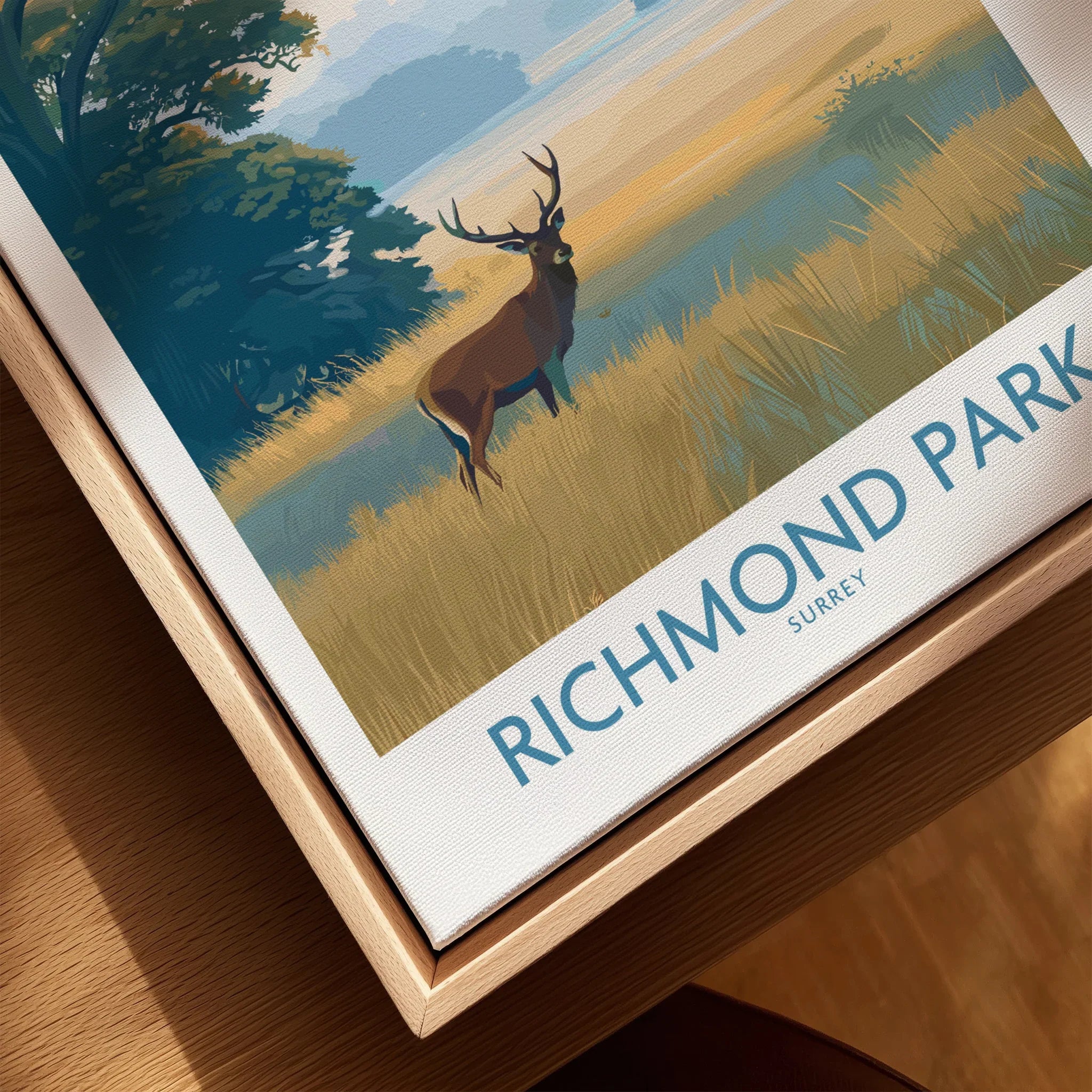 Closeup of Richmond Park travel poster print with deer, framed in natural wood.