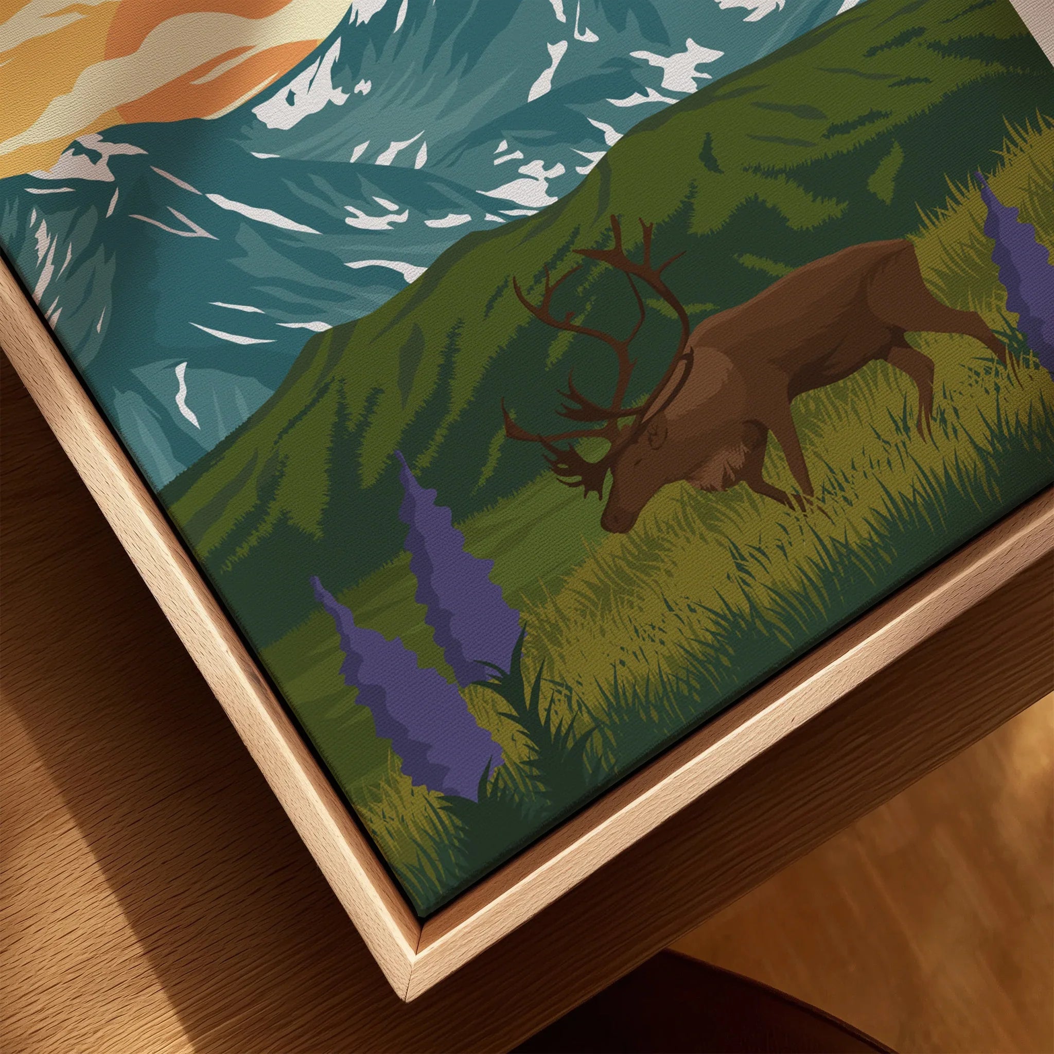 Closeup of a framed Rocky Mountain National Park print with elk and wildflowers in a natural wood floating frame.