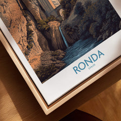 Ronda Spain Poster | Dramatic Andalusian Mountain Bridge Canvas Print displayed on a wooden frame with scenic artwork.