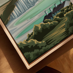 Close-up of framed canvas wall art featuring landscape with green hills and houses