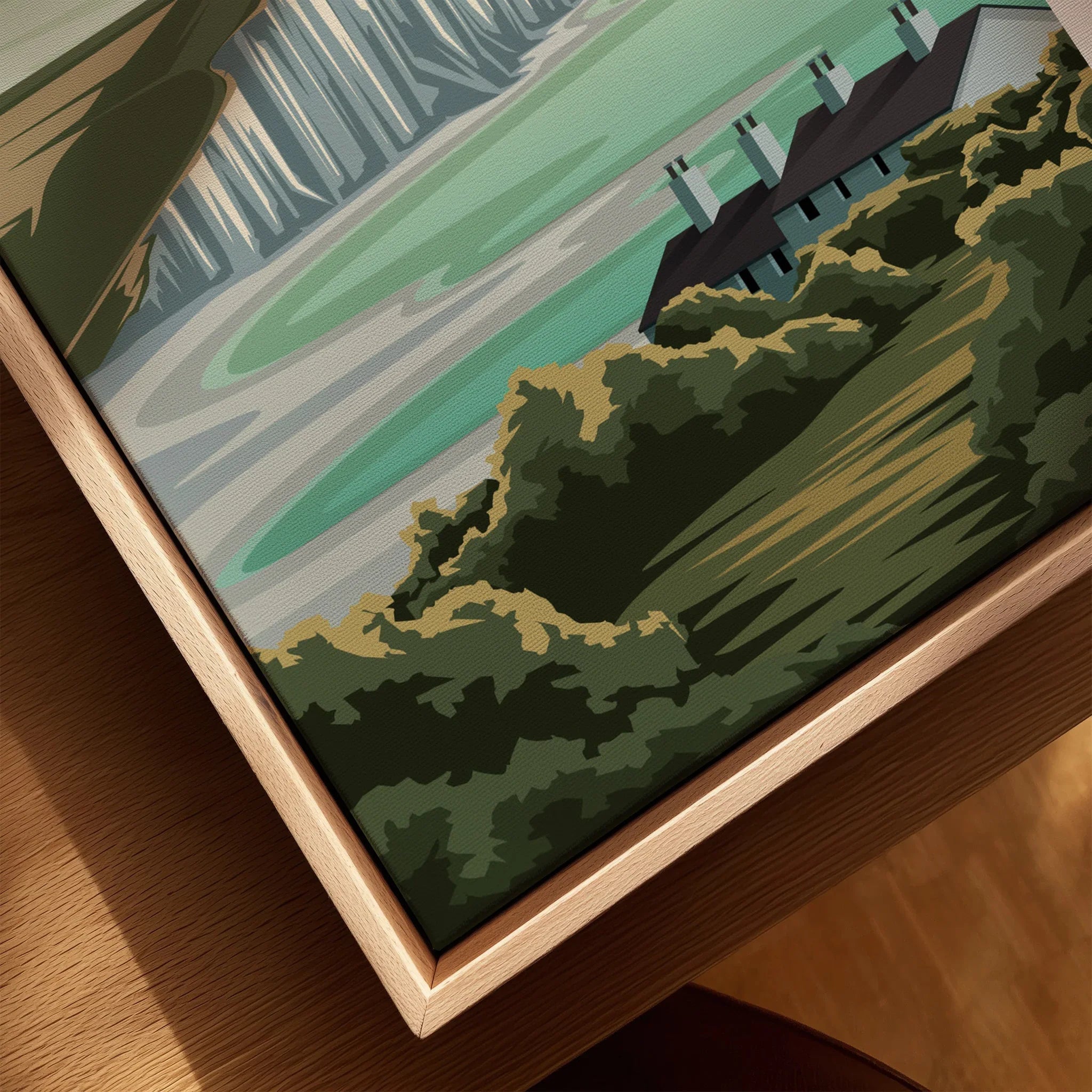 Close-up of framed canvas wall art featuring landscape with green hills and houses