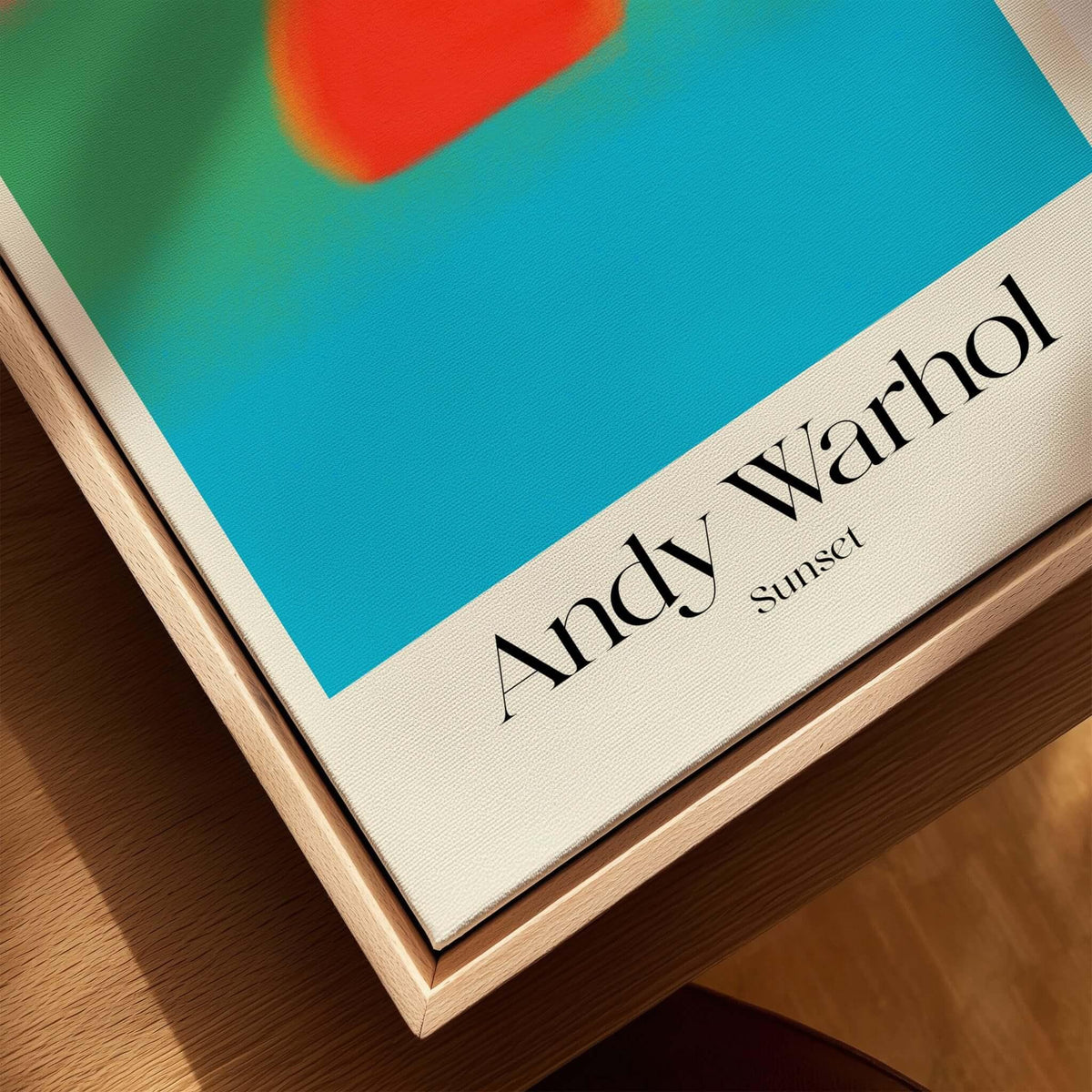 Andy Warhol Sunset Coral Green Blue Pop Art Poster Abstract Wall Art Print Modern displayed on a wooden table.