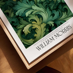 William Morris Prints - Green Acanthus Swirl Pattern Art Print - Botanical Foliage Poster on a wooden surface.