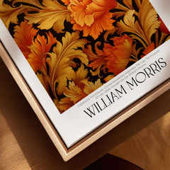 William Morris Prints - Orange Gold Floral Pattern Art Print - Dark Botanical Poster displayed on a wooden surface.