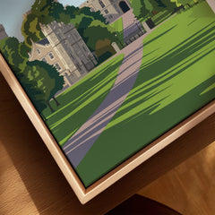 Closeup of framed canvas wall art with a scenic castle and green landscape illustration.