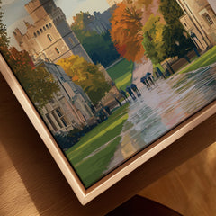 Closeup of framed canvas wall art with castle, autumn trees, and people walking on path