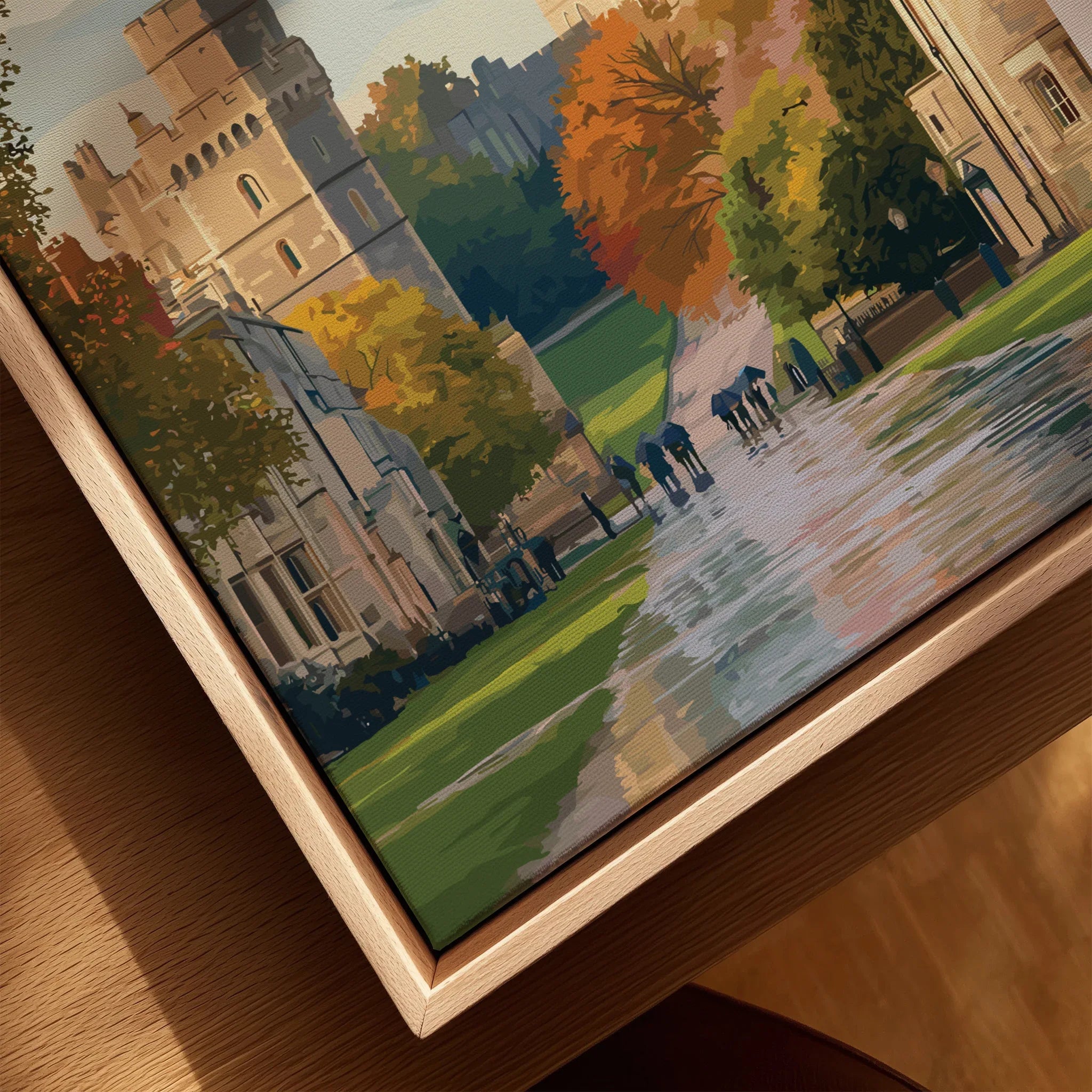 Closeup of framed canvas wall art with castle, autumn trees, and people walking on path