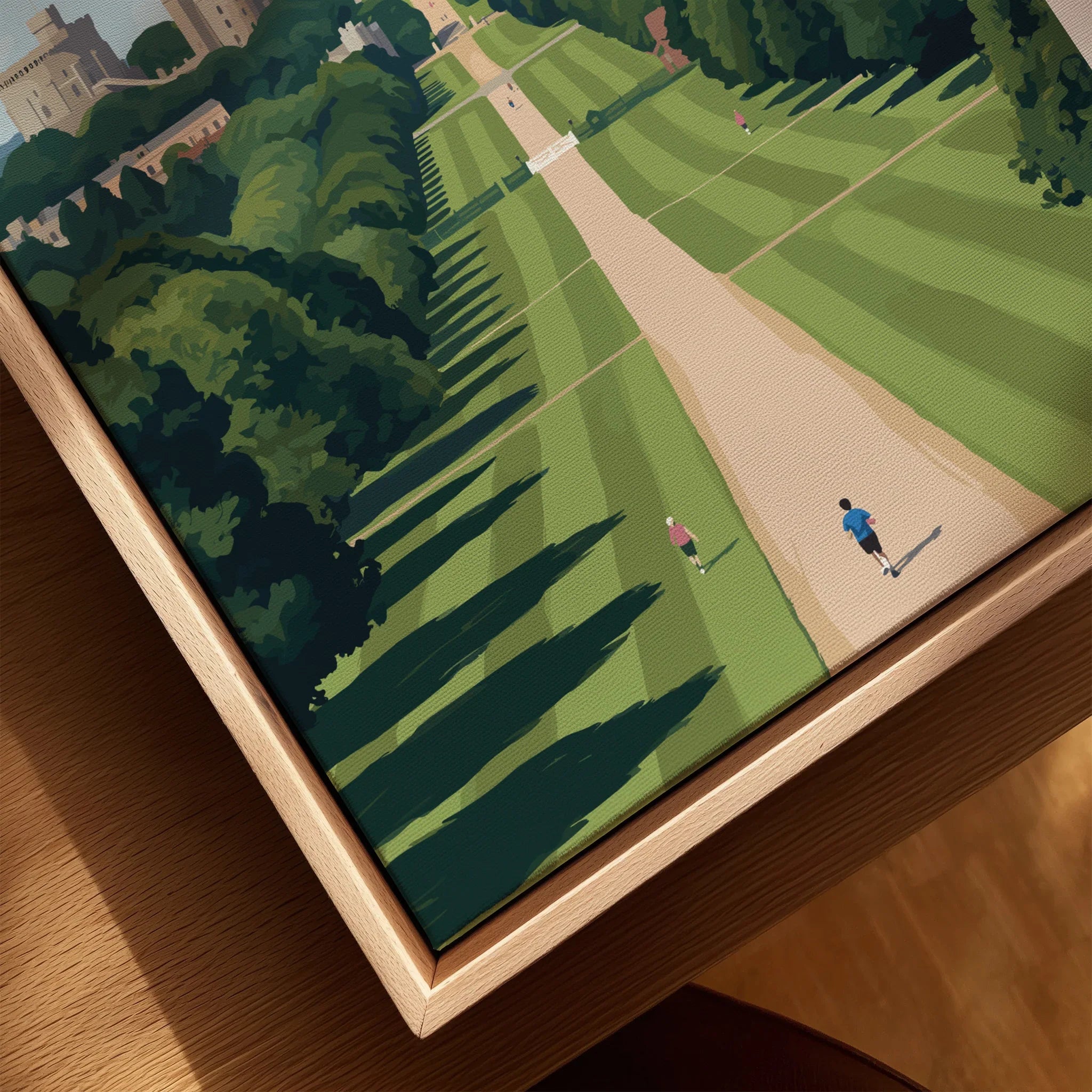 Closeup of framed canvas print with scenic park walkway, green lawns, and joggers, in a natural wood floating frame