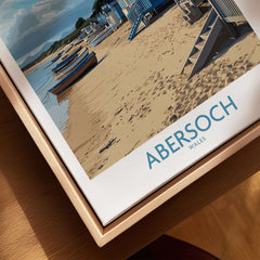 Abersoch Wales Beach Huts Art Print | Coastal Boats Wall Decor Poster featuring colorful beach huts and boats on sandy shore.