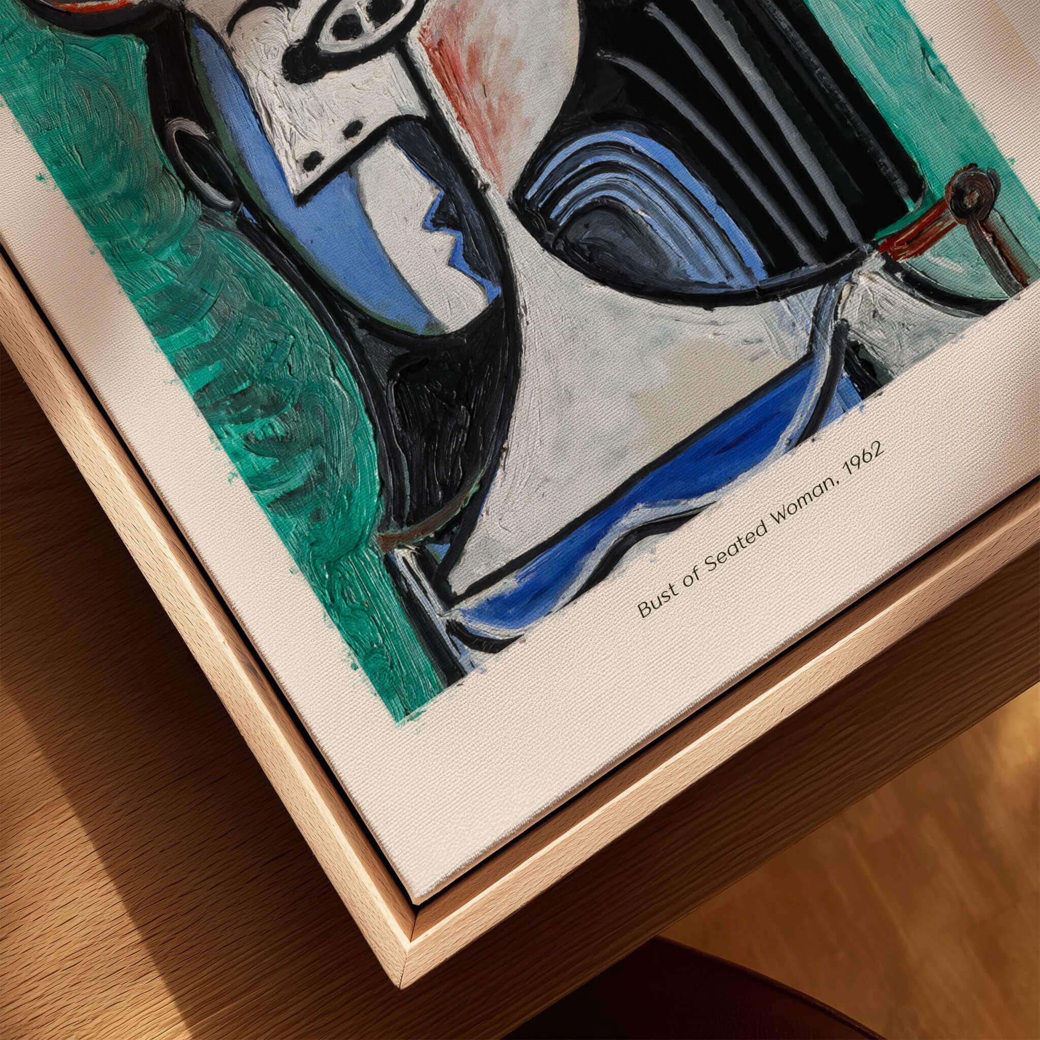 Picasso Bust Seated Woman 1962 Art Print Abstract Portrait Poster Colorful Wall Art displayed on a wooden table.
