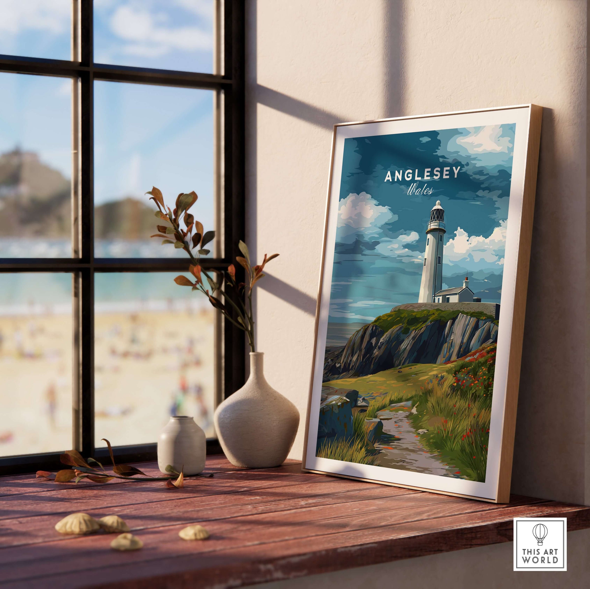 Anglesey Wales Lighthouse on Cliffs Print - Coastal Path Wall Art displayed indoors next to a window with a beach view.