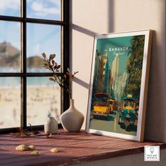 Bangkok Thailand Poster Tuk Tuk Street Scene - Thai Print displayed on a wooden table near a window.