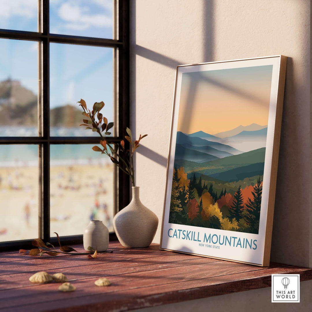Catskill Mountains New York fall landscape poster on a shelf by a window, showcasing autumn colors and scenic views.