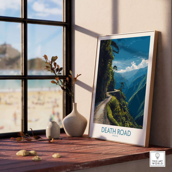 Death Road Bolivia Mountain Art Print | Yungas Camino Poster framed on a wooden table by a sunny window.