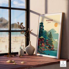 Hakone Japan Lake Ashi Temple Print - Japanese Pagoda Wall Art displayed in a bright room with a vase and stones.