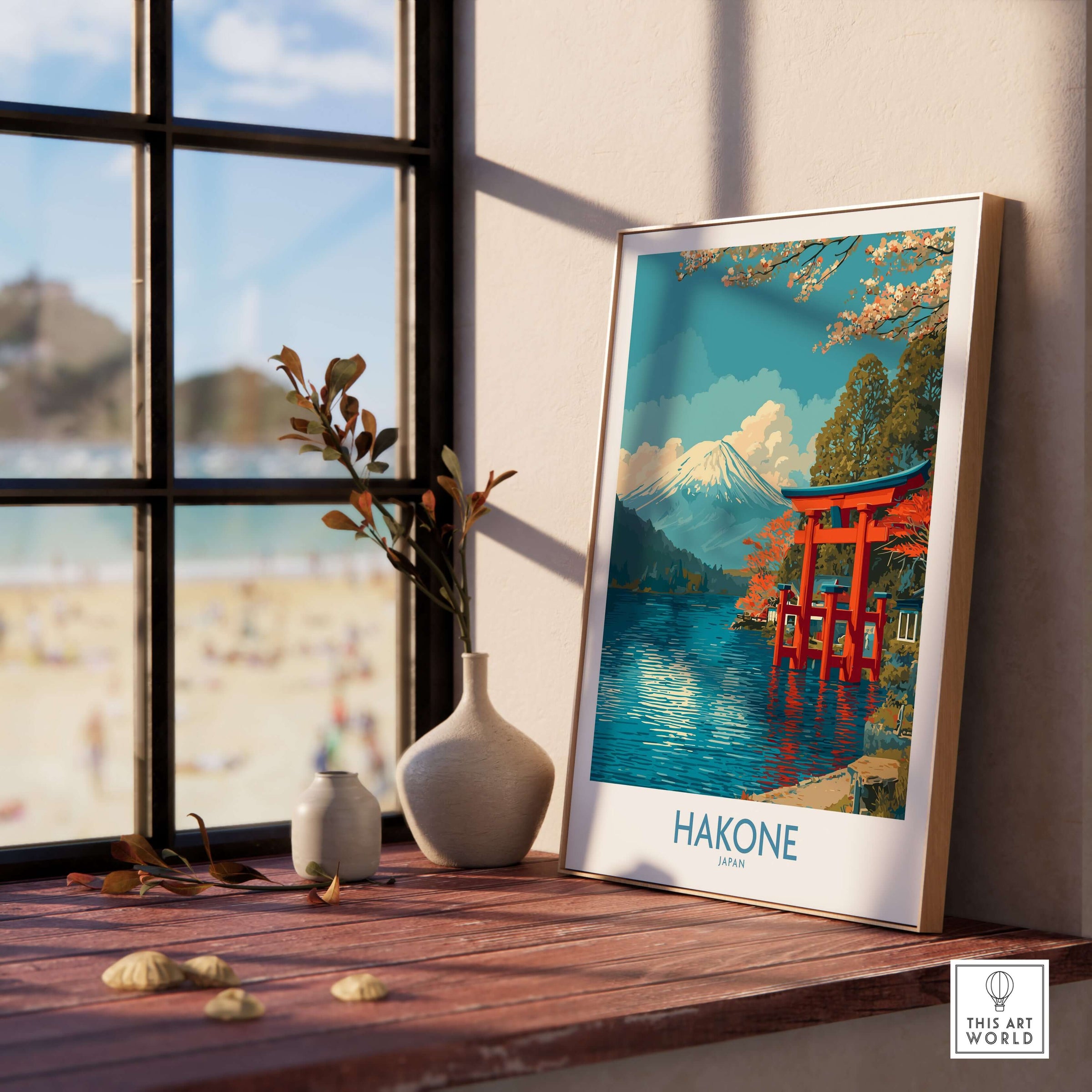 Hakone Wall Art Japan Red Torii Gate Poster displayed on a wooden table near a window with a serene landscape.