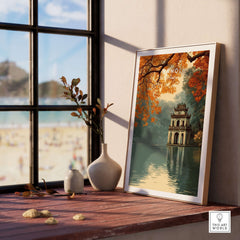 Hanoi Vietnam Poster - Hoan Kiem Lake Temple Print displayed in a bright, serene room by a window with autumn leaves.