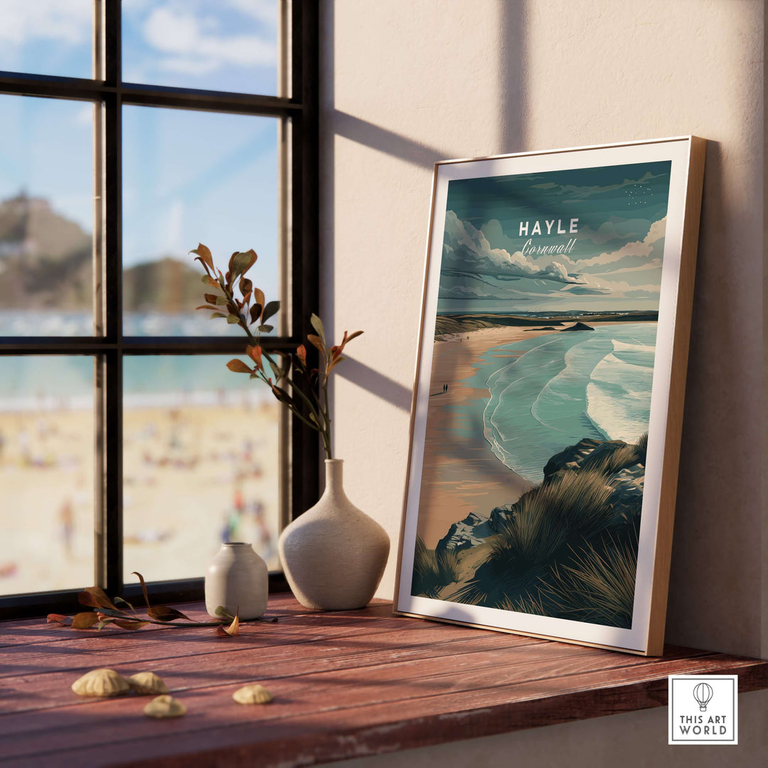 Framed Hayle Cornwall Coastal Beach print on a wooden table, overlooking serene ocean views and beach scenery.