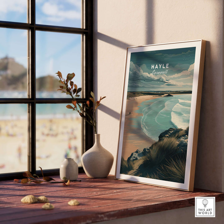 Framed Hayle Cornwall Coastal Beach print on a wooden table, overlooking serene ocean views and beach scenery.