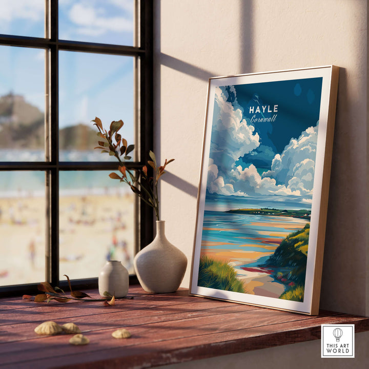 Hayle Ocean View print showcasing Cornwall's coastline, framed on a wooden shelf with a beach view outside.