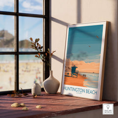 Huntington Beach Surfing Beach Poster - California Travel Decor displayed on a windowsill with beach view.