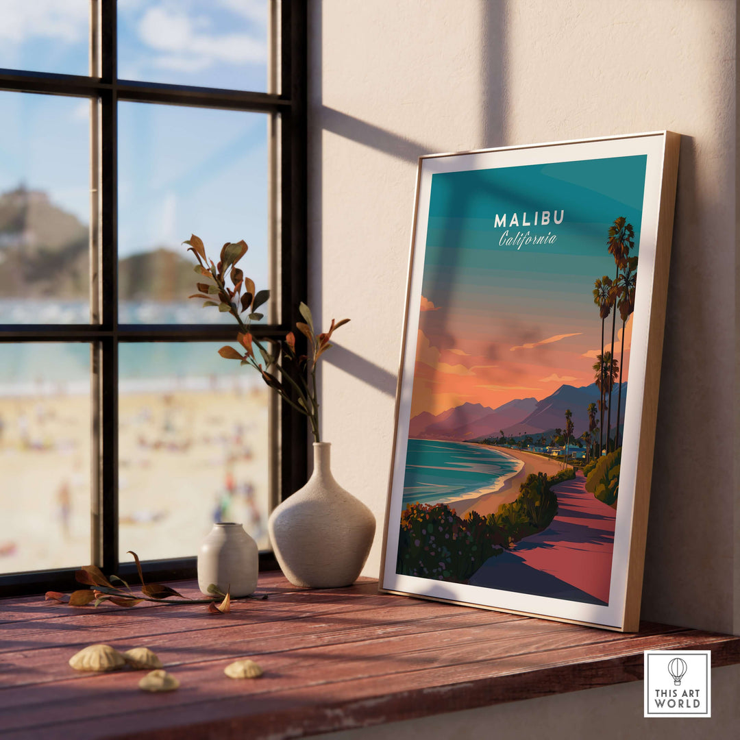 Malibu beach sunset print framed on a table with a coastal view, showcasing vibrant colors and serene atmosphere.