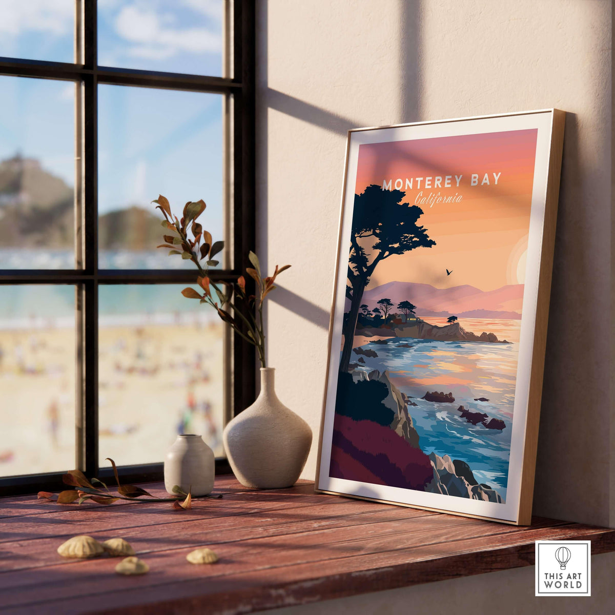 Monterey Bay California Sunset Coastline Poster - Cypress Tree Wall Art displayed on a wooden table by a window.
