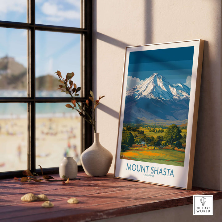 Mount Shasta California poster displayed on a wooden table near a window, showcasing the mountain's majestic beauty.