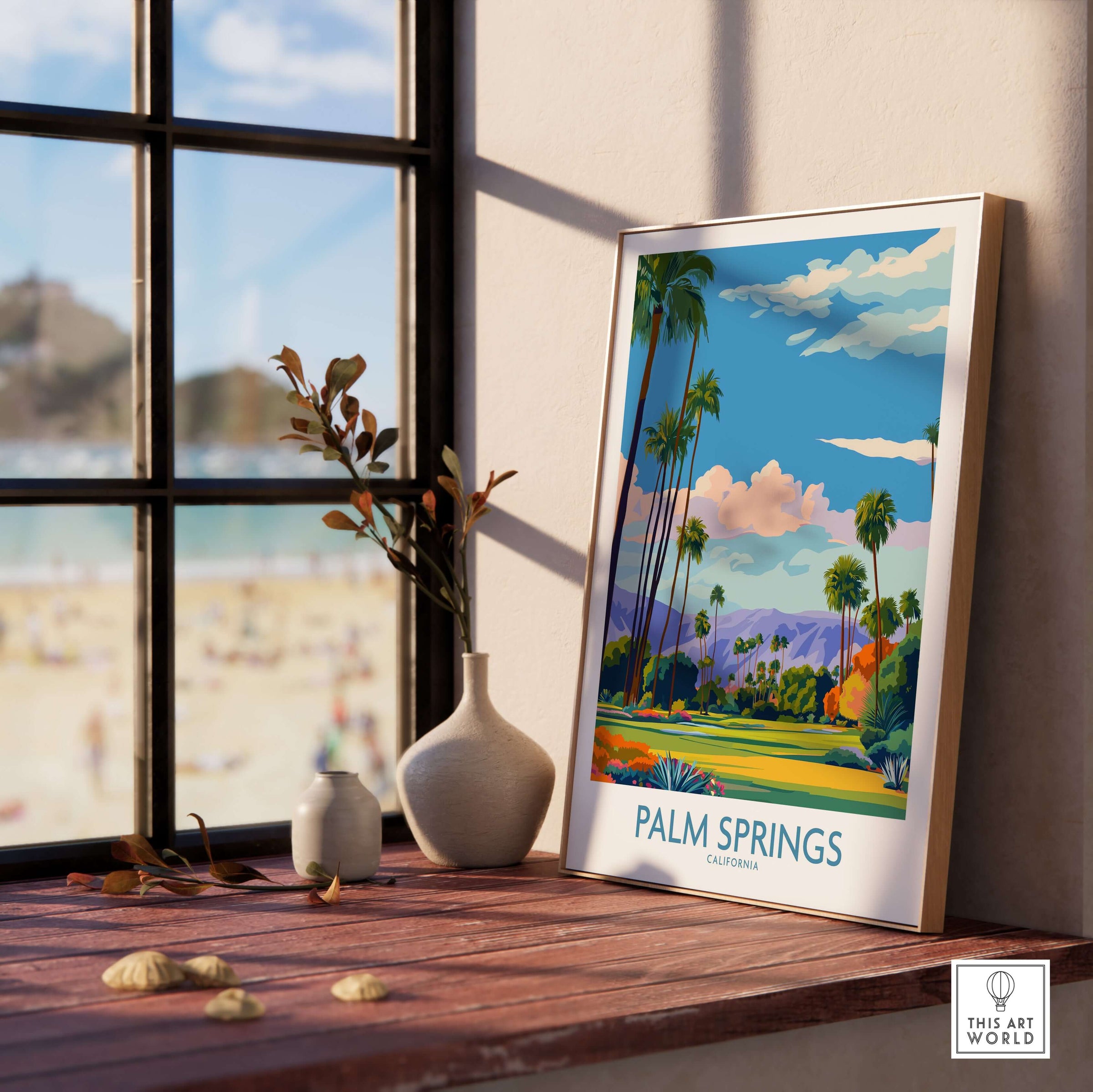 Palm Springs Palm Tree Oasis Wall Art - California Travel Poster displayed near a sunny window with a beach view.