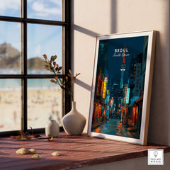 Seoul South Korea Poster N Seoul Tower Print displayed in a cozy interior with a view of the beach.