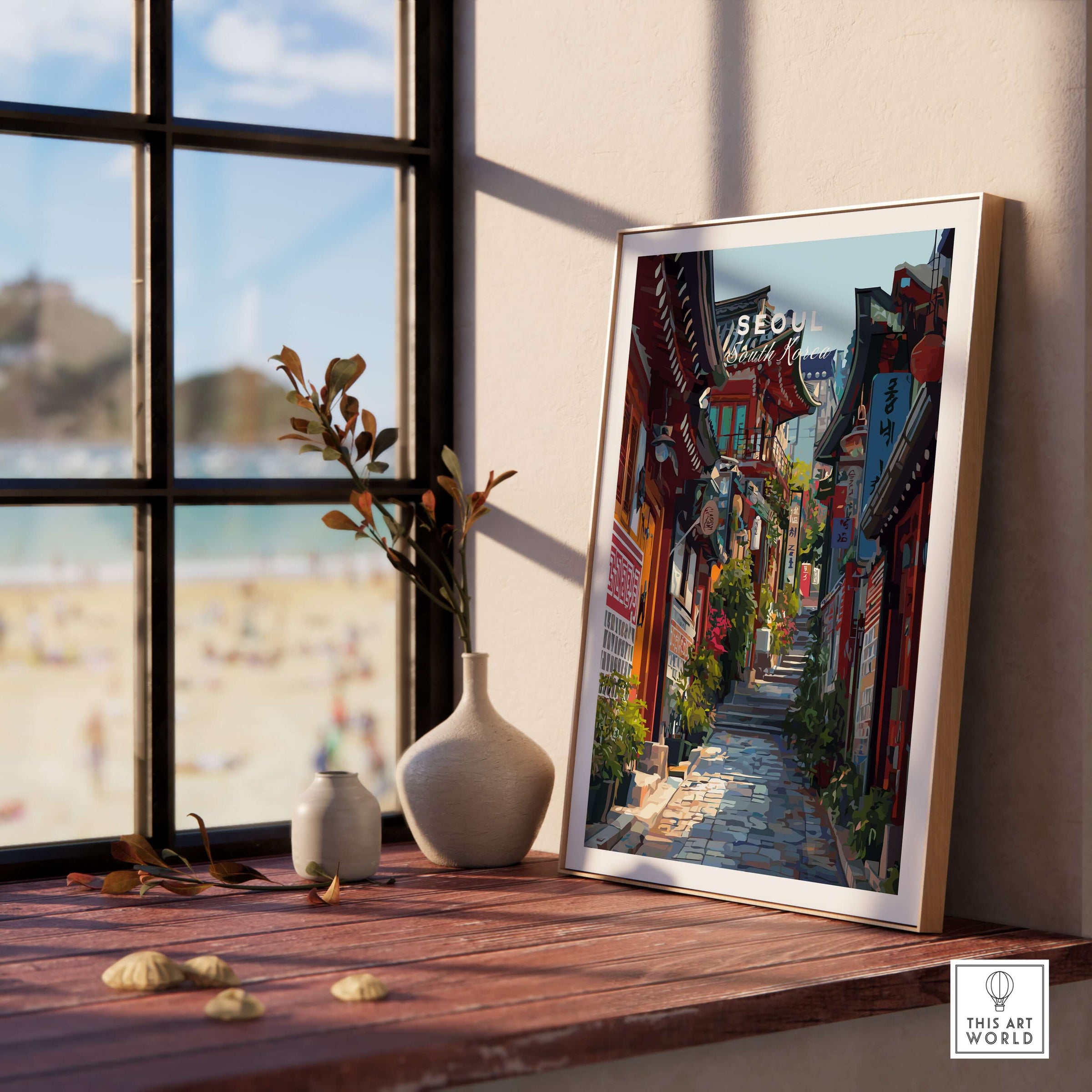 Seoul South Korea Print - Historic Korean Street Wall Art displayed on a wooden table next to a vase, capturing vibrant street scenes.