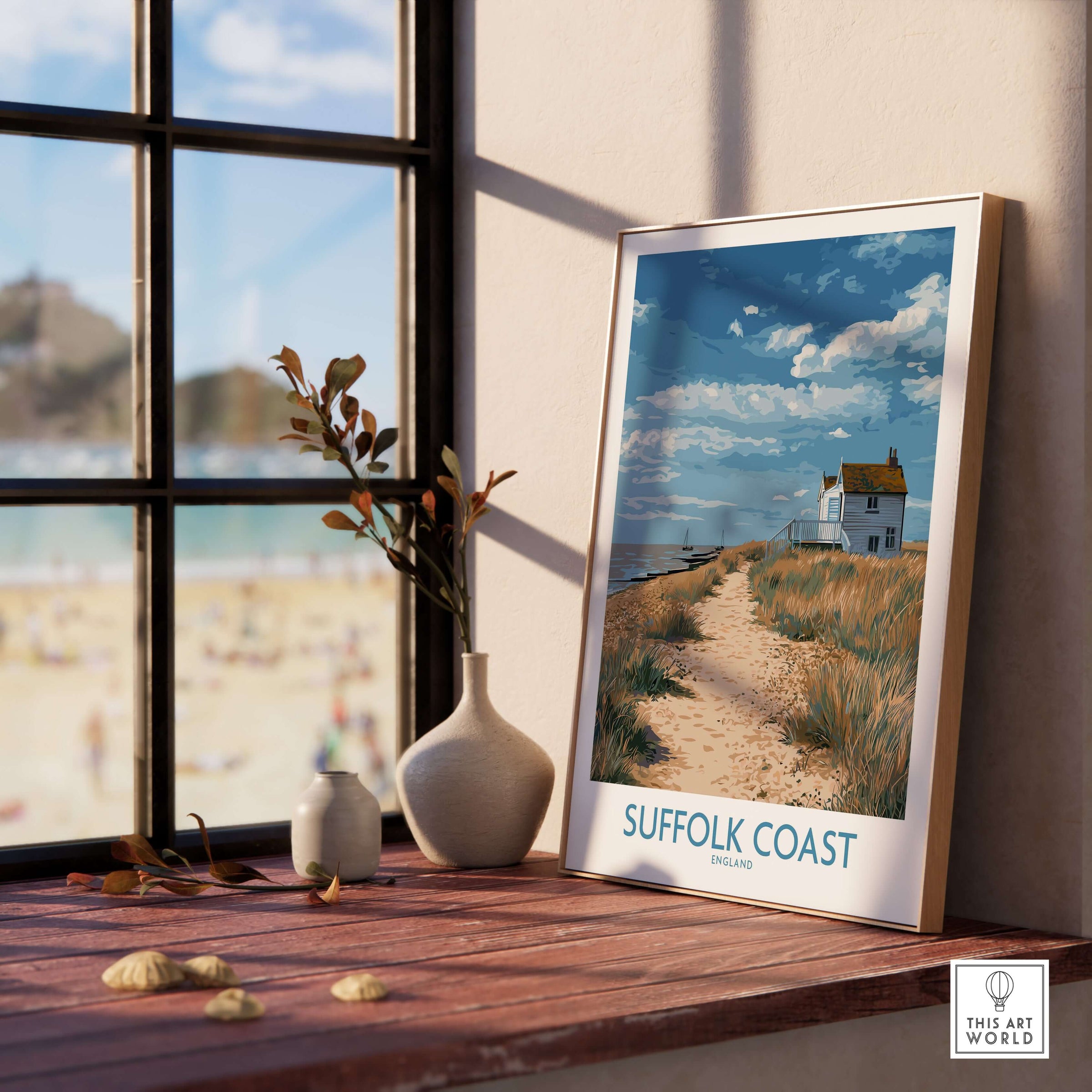 Suffolk Coast England English Shoreline Poster - Rural Landscape Travel Decor displayed on a wooden table by a window.