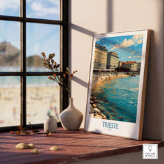 Trieste Italy Wall Art - Italian Travel Poster displayed on a wooden table by a window, showcasing coastal beauty.