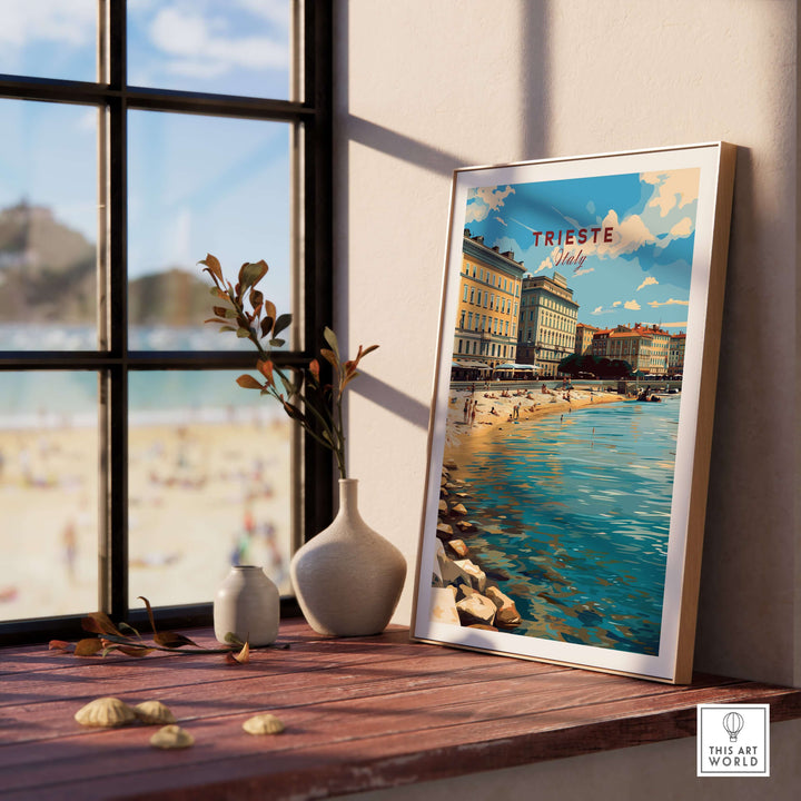 Trieste poster on a wooden table by the window, showcasing scenic views of the coastal city in Italy.