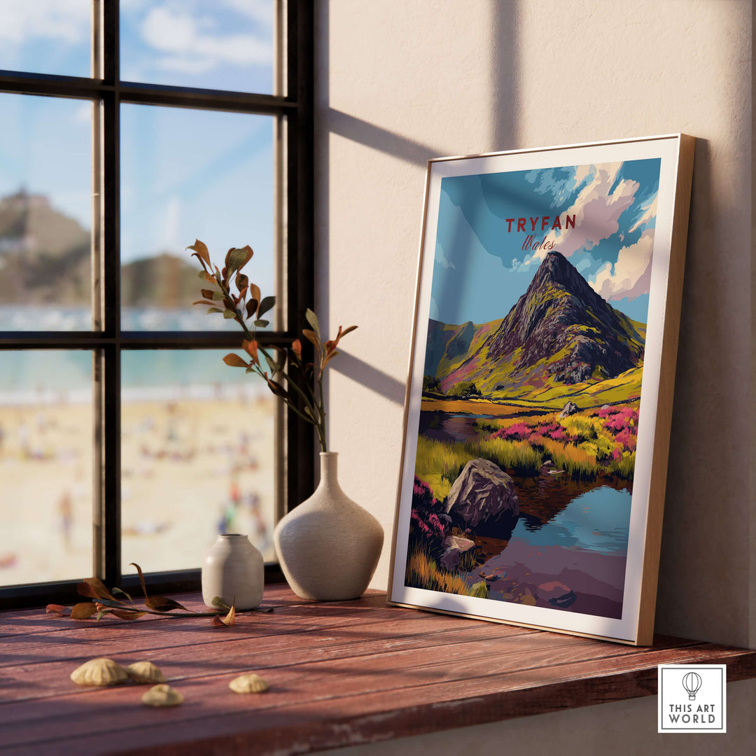 Framed Tryfan mountain landscape print on a wooden table with vase, showcasing Snowdonia's beauty.