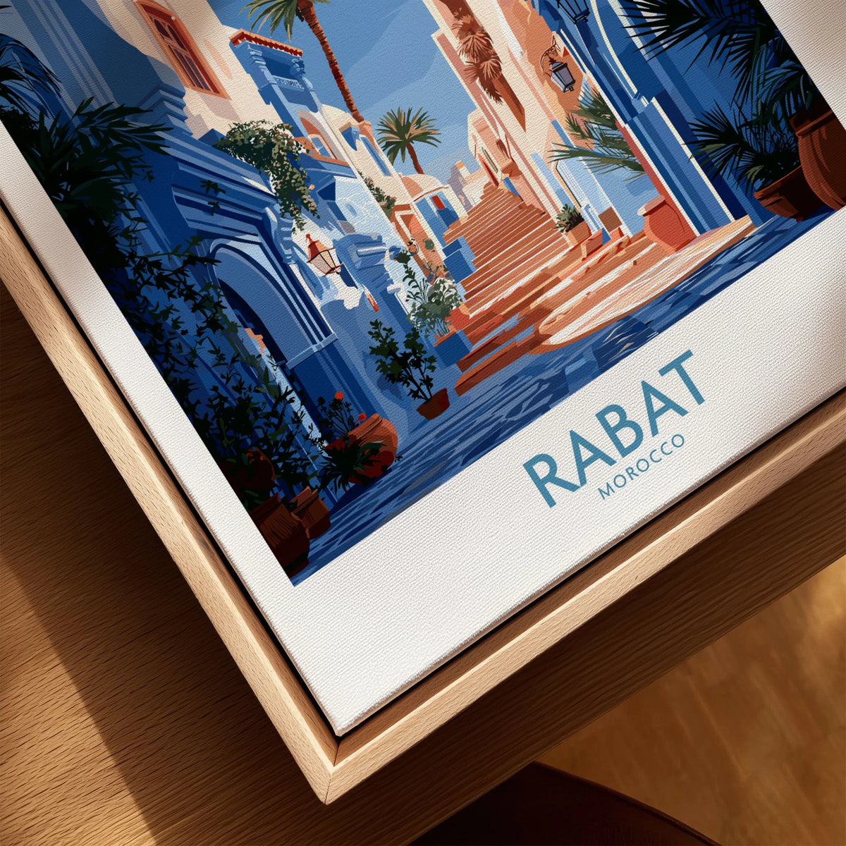 Rabat Morocco Blue Alleyway Wall Art — a blue-washed medina lane and stone steps seen through a horseshoe arch, shown as closeup framed canvas natural wood floating frame