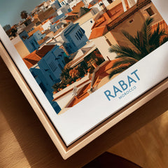 Rabat Morocco Minaret Skyline Wall Art — medina rooftops and a pale minaret in late afternoon sun, shown as closeup framed canvas natural wood floating frame