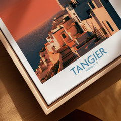 Tangier Morocco Coastal Sunset Wall Art — a whitewashed hillside town and minaret glowing above the sea at sunset, shown as closeup framed canvas natural wood floating frame