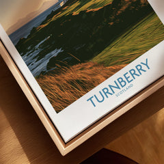 Turnberry Scotland Rocky Shore Wall Art — the Turnberry lighthouse above a rocky shore with the Arran hills beyond, shown as closeup framed canvas natural wood floating frame