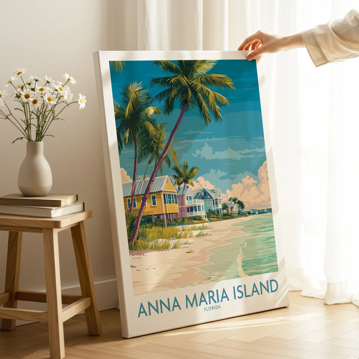 Hand holding Anna Maria Island canvas print with beach, palm trees, and coastal houses in room