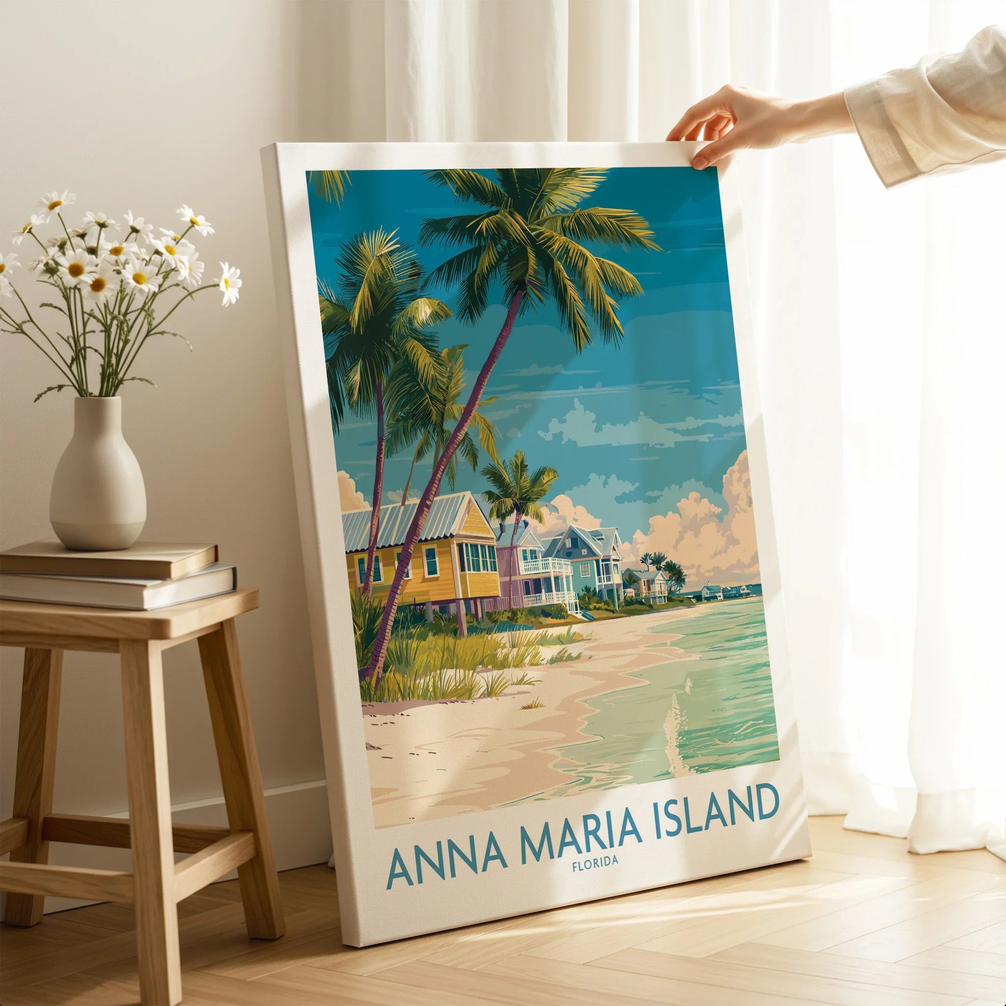 Hand holding Anna Maria Island canvas print with beach, palm trees, and coastal houses in room