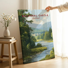 Hand holding Balmoral Castle Scotland travel poster canvas print in cozy room setting