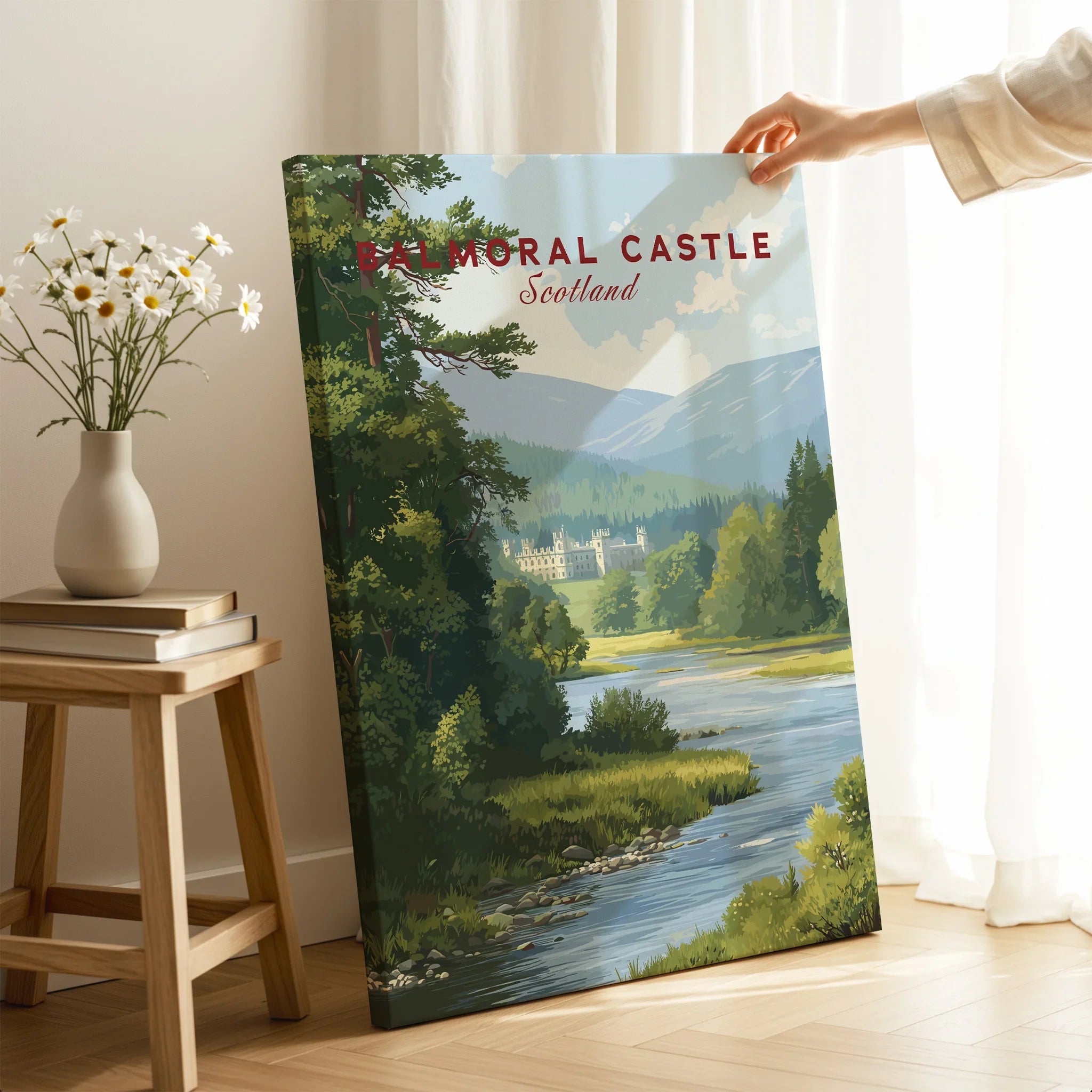 Hand holding Balmoral Castle Scotland travel poster canvas print in cozy room setting