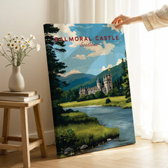 Hand holding Balmoral Castle Scotland travel poster print in modern home setting