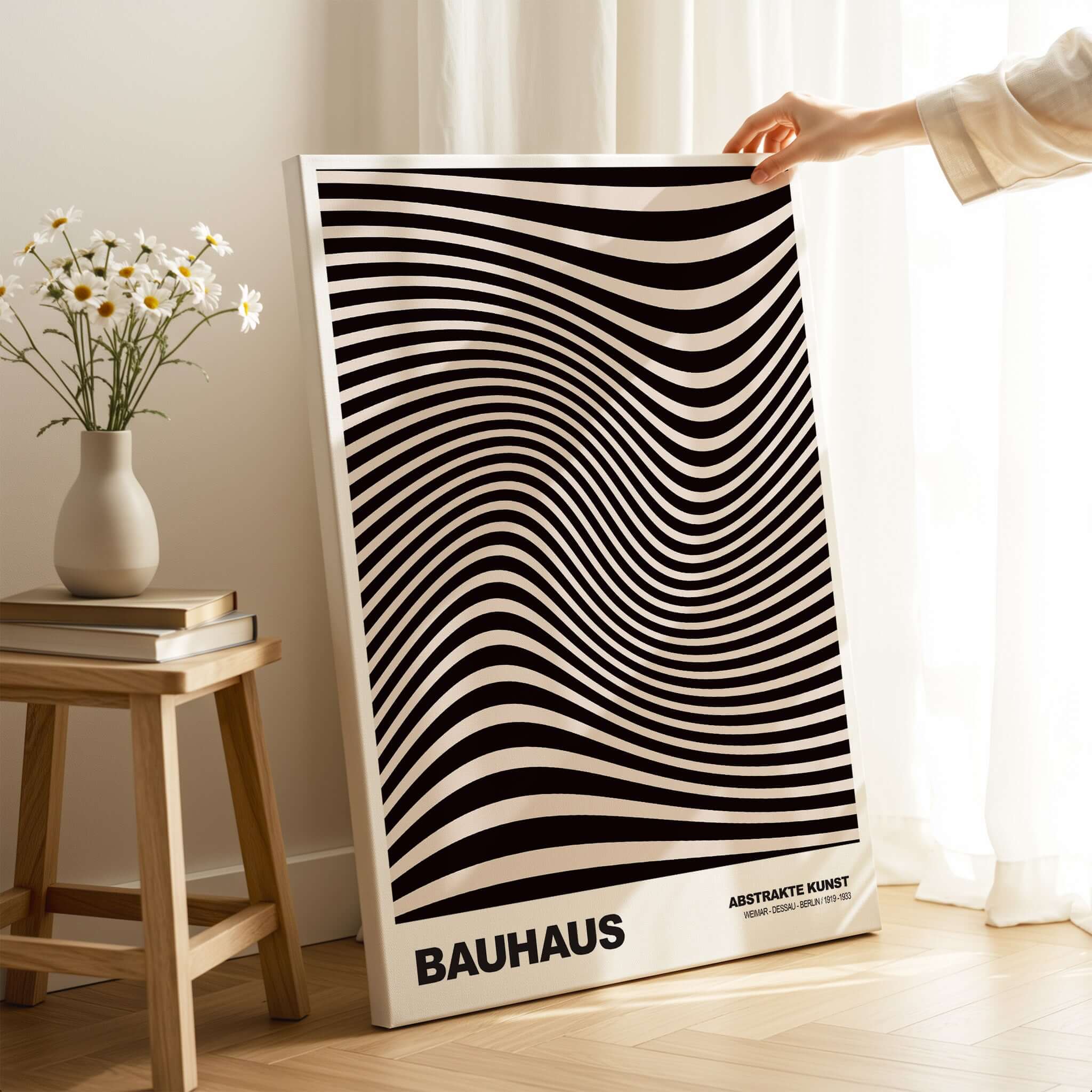 Bauhaus Exhibition Prints -  Optical Wave Lines Art Print Black Cream Abstract displayed in a bright room with a flower vase.