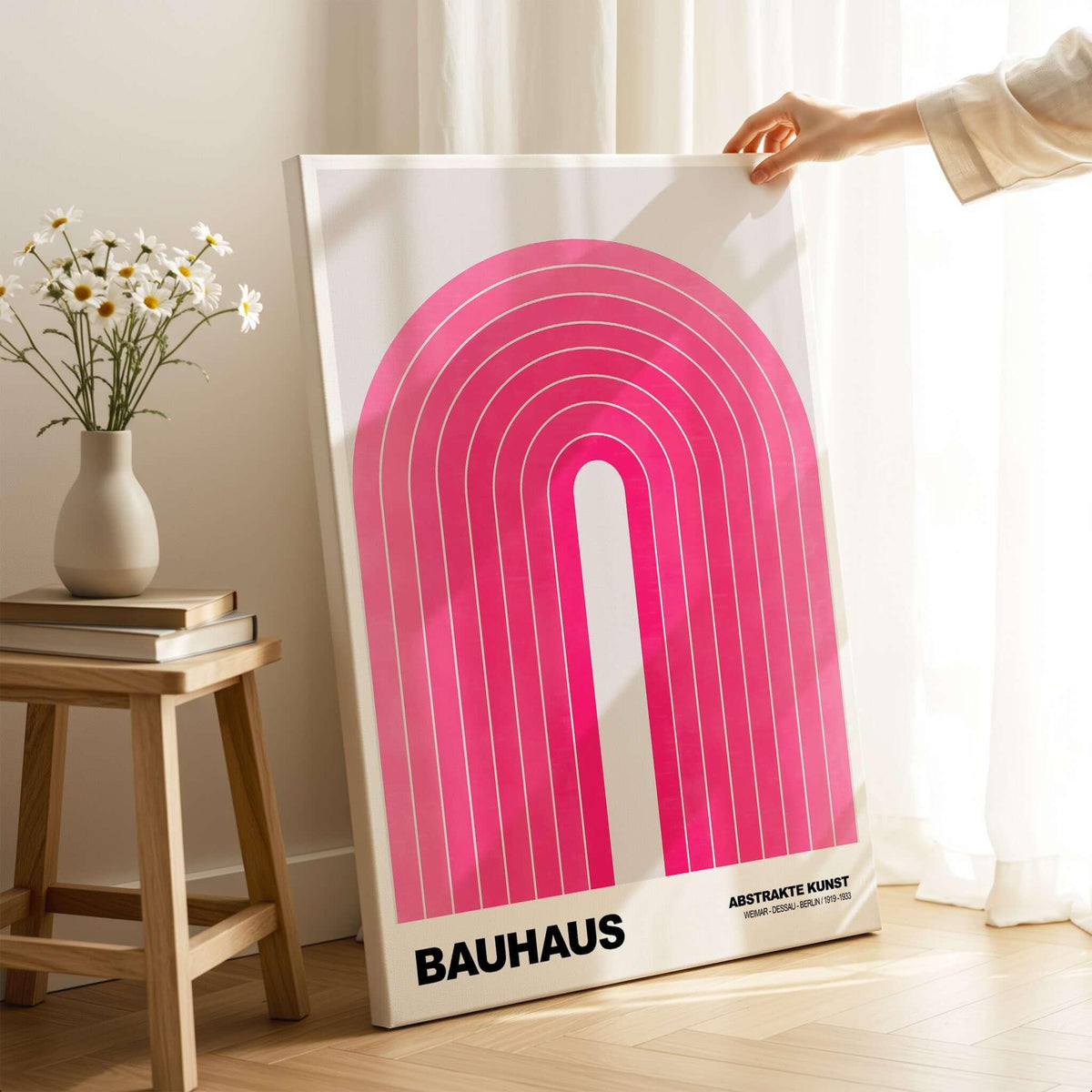 Bauhaus Exhibition Prints - Concentric Pink Arch Poster Minimalist Geometric Art displayed on a stand with flowers.