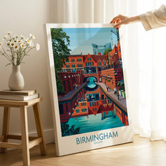 Hand holding Birmingham cityscape travel poster canvas print in modern home decor setting