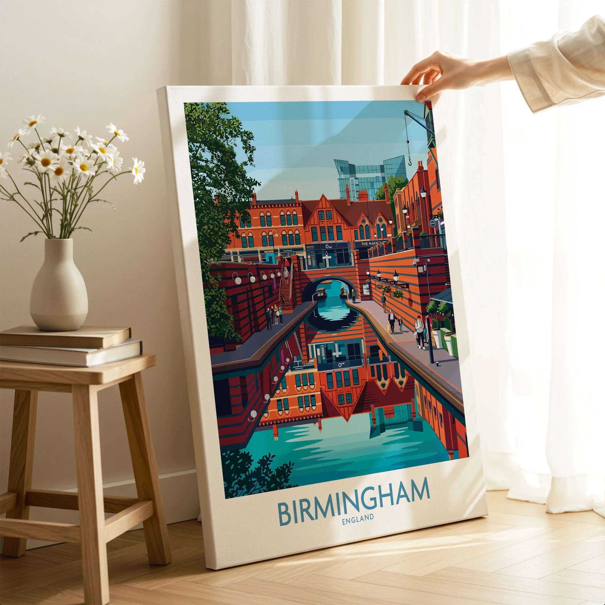 Hand holding Birmingham cityscape travel poster canvas print in modern home decor setting