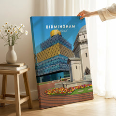 Birmingham England cityscape canvas print held in modern room with flowers and books